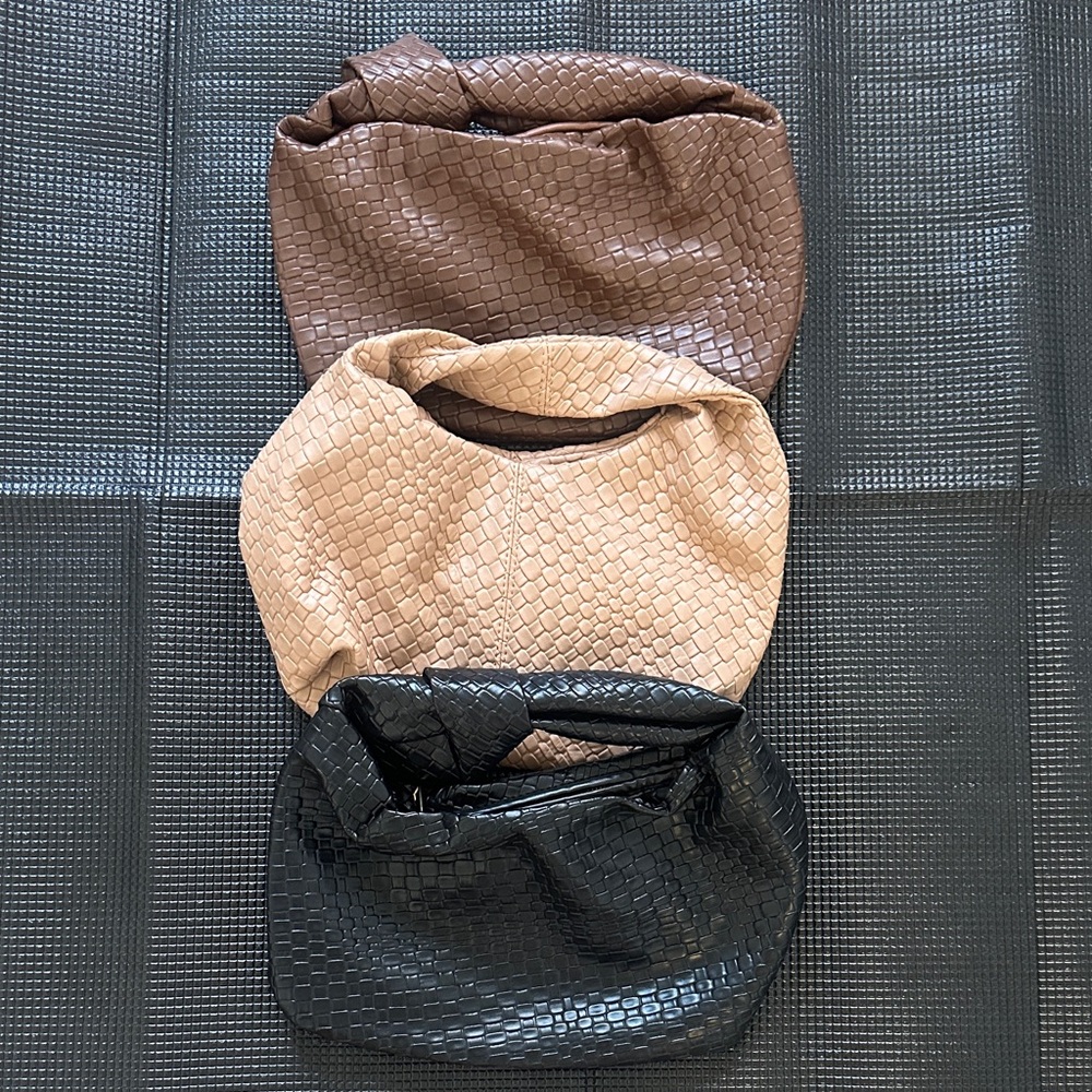 Set of Three Woven Textured Bags in Brown, Tan, and Black.